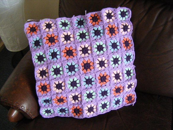 Purple crocheted cushion cover